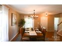 Elegant dining room featuring hardwood floors, a chandelier, and room to seat eight at 513 Buttercup Way, Fort Mill, SC 29715