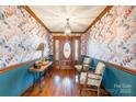 Elegant hallway with decorative wallpaper, stylish furnishings, and a grand front door at 529 Langley Rd, Lancaster, SC 29720