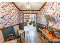 Charming hallway featuring floral wallpaper, rich hardwood floors, and stylish furnishings at 529 Langley Rd, Lancaster, SC 29720