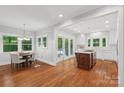 Open kitchen and dining area with hardwood floors and a kitchen island, complemented by natural light at 545 Dilworth Mews Ct, Charlotte, NC 28203