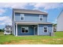 Spacious backyard with a covered patio, perfect for outdoor entertaining and relaxation at 5626 Skinny Dr, Charlotte, NC 28215