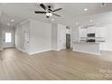 Open-concept living room featuring hardwood floors and ample natural light, great for entertaining at 5626 Skinny Dr, Charlotte, NC 28215