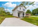 Charming two-story home featuring a crisp white exterior, black accents, and a well-manicured lawn at 600 Legrand St, Shelby, NC 28150