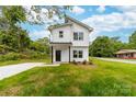 Charming two-story home featuring a crisp white exterior, black accents, and a well-manicured lawn at 600 Legrand St, Shelby, NC 28150