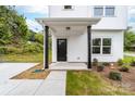 Inviting front porch with black support beams, a dark door, and tasteful landscaping at 600 Legrand St, Shelby, NC 28150
