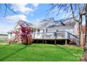 Expansive backyard featuring a wooden deck, lush lawn, and partial fence; perfect for outdoor gatherings at 705 Sagrada Dr, York, SC 29745
