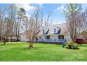 Charming home with a spacious front yard, covered porch, and attached garage on a sunny day at 705 Sagrada Dr, York, SC 29745