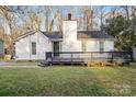 Charming exterior with a cozy front porch and white siding, surrounded by mature trees at 8220 Terra Linda Ln, Charlotte, NC 28215