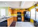 Open kitchen features a black appliance suite and tile flooring at 9220 Pinaceal Ct, Charlotte, NC 28215