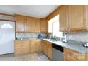 Bright kitchen featuring tile floors, granite counters, light wood cabinets and stainless steel appliances at 103 Perry St, Shelby, NC 28150