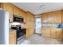 Well-lit kitchen with light wood cabinetry, tile backsplash, and modern stainless steel appliances at 103 Perry St, Shelby, NC 28150