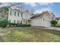 Traditional home with a well-manicured lawn and two-car garage at 10434 Henbane Ct, Charlotte, NC 28213