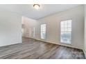 Bright living room with gray wood floors and natural light at 10434 Henbane Ct, Charlotte, NC 28213