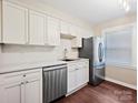 Bright kitchen showcases stainless steel appliances, white cabinetry and subway tile backsplash at 107 S Laurel Ave # 101A, Charlotte, NC 28207