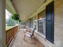 Inviting front porch with rocking chairs and views of the landscaped front yard at 1115 Kelly Rd, Mount Holly, NC 28120