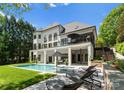 Beautiful backyard with a sparkling pool, lounge area, and lush greenery at 12014 James Jack Ln, Charlotte, NC 28277
