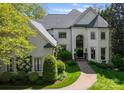 Charming two-story home featuring a well-manicured lawn and lush landscaping at 12014 James Jack Ln, Charlotte, NC 28277
