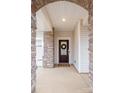 Front door of the home with beautiful stone surround and craftsman style architecture at 129 Doncaster Dr, Mooresville, NC 28115