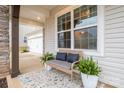 Cozy front porch with a bench, potted plants, and an outdoor rug, perfect for relaxing at 129 Doncaster Dr, Mooresville, NC 28115
