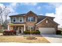 Charming two-story home with brick facade, covered porch, and well-manicured landscaping at 13240 Carolina Wren Ct, Charlotte, NC 28278