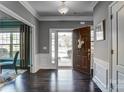 Elegant foyer with dark wood floors, white trim, and a view to the front door at 13240 Carolina Wren Ct, Charlotte, NC 28278