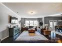 Spacious living room with a large sectional sofa, dark wood floors, and an abundance of natural light at 13240 Carolina Wren Ct, Charlotte, NC 28278