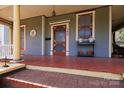 Charming front porch with detailed columns, red-painted flooring, and decorative touches for an inviting entrance at 143 Reid St, Rock Hill, SC 29730