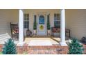 Inviting front porch with rocking chair and bench seating, flanked by classic columns at 1505 Angela Ct, Lincolnton, NC 28092