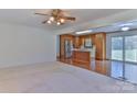 Open-concept living area with carpet, and seamless flow into a kitchen with wood cabinets at 1630 26Th Ne St, Hickory, NC 28601