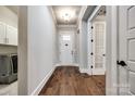 Inviting hallway with hardwood floors, white trim, and doors leading to other rooms at 1891 Felts Pkwy, Fort Mill, SC 29715