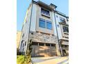 Three story townhouse with a stone base and attached garage at 1922 Hamorton Pl, Charlotte, NC 28205
