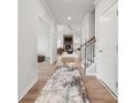 Bright hallway featuring hardwood floors, leading to an open-concept living area with a fireplace at 2033 Mantle Ridge Dr, Indian Trail, NC 28079