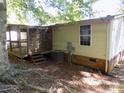 Back exterior showing an enclosed patio and air conditioning unit at 2130 Babbling Brook Ln, Gastonia, NC 28052
