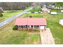 A single-story home featuring a metal roof, well-maintained yard, and attached garage at 2180 Grace Church Rd, Salisbury, NC 28147