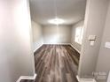 Bright, neutral living room featuring vinyl wood flooring and a large window for ample natural light at 2180 Grace Church Rd, Salisbury, NC 28147