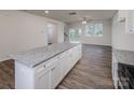 Stylish kitchen with granite counters, white cabinets and island with sink at 2583 Watson Dr, Lancaster, SC 29720