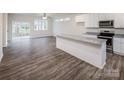 Modern kitchen and living room with sleek appliances, island and open layout, perfect for entertaining at 2583 Watson Dr, Lancaster, SC 29720