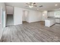 Spacious open-concept living room featuring wood floors, a staircase, and a kitchen island with granite countertops at 2591 Watson Dr, Lancaster, SC 29720
