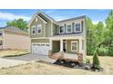 Charming two-story home with a two-car garage and inviting front porch at 2822 Woodlands Creek Dr, Monroe, NC 28110