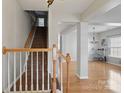 Inviting foyer with hardwood floors, staircase, and elegant chandelier, leading to the open-concept living area at 3812 Caldwell Ridge Pkwy, Charlotte, NC 28213