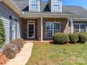Inviting entrance featuring brick accents, manicured shrubs, and a well-lit walkway to the front door at 3816 Sonoma Way, Monroe, NC 28110