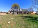 A single story home with a well manicured front lawn and mature trees under a clear blue sky at 3816 Sonoma Way, Monroe, NC 28110