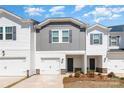 Inviting exterior view of the townhome featuring a one car garage and manicured landscaping at 3870 County Down Ave, Kannapolis, NC 28081