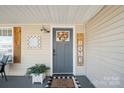 A quaint front porch featuring decor, plants, and a 'Home Sweet Home' welcome mat at 41 Selma Dr, Mooresville, NC 28115
