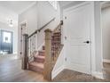 Hallway featuring carpeted stairs, light hardwood floors and white trim at 522 Fern Hill Rd # 17, Mooresville, NC 28117