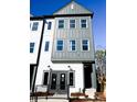 Modern townhome featuring gray and white siding, with a striking multi-story facade and stylish entryway at 8026 Cedarsmith Ct, Charlotte, NC 28217