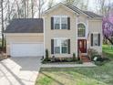 Beautiful two-story home with a well-manicured lawn, flower beds and attached two-car garage at 8509 Piccone Brook Ln, Charlotte, NC 28216