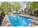 Large in-ground pool with diving board, ladders, and ample decking, perfect for summer fun and relaxation at 8704 Dartmoor Pl, Mint Hill, NC 28227