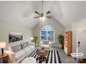 Bright, airy living room featuring vaulted ceilings, a ceiling fan, a large window, and stylish furniture at 89 Fifth St, York, SC 29745