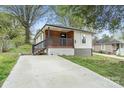 Inviting single-story home with a spacious driveway and charming front porch at 902 Grace St, Kings Mountain, NC 28086